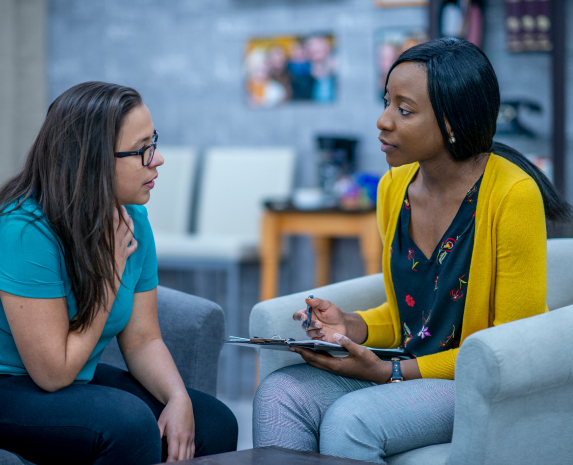 A patient speaking intently to an occupational therapist